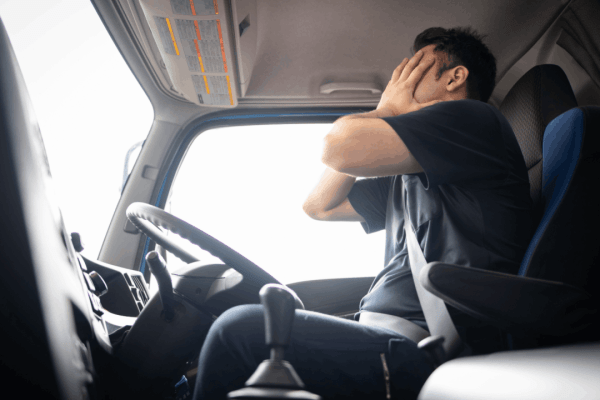 How to document emotional trauma for a truck accident claim showing distressed driver experiencing psychological symptoms in commercial vehicle