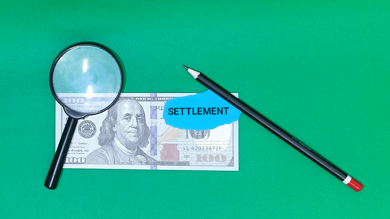 How to know if a truck accident settlement offer is fair shown through magnifying glass examining settlement money and compensation details