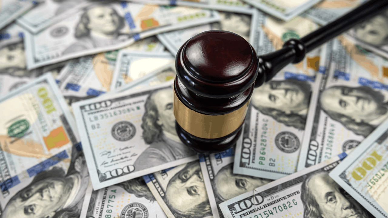 How much money victims receive when hit by a commercial truck illustrated by gavel on hundred dollar bills representing settlement compensation