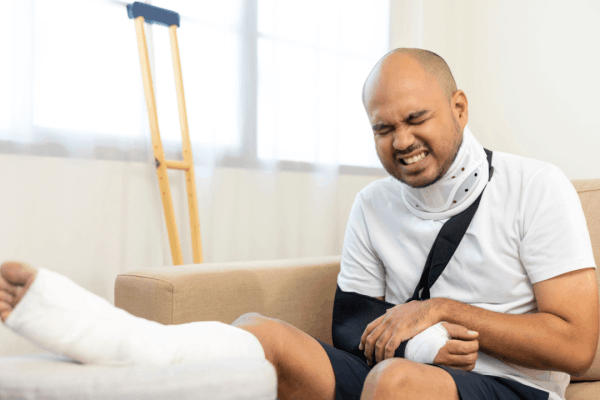 Man with neck brace and cast calculating pain and suffering compensation after a truck accident claim