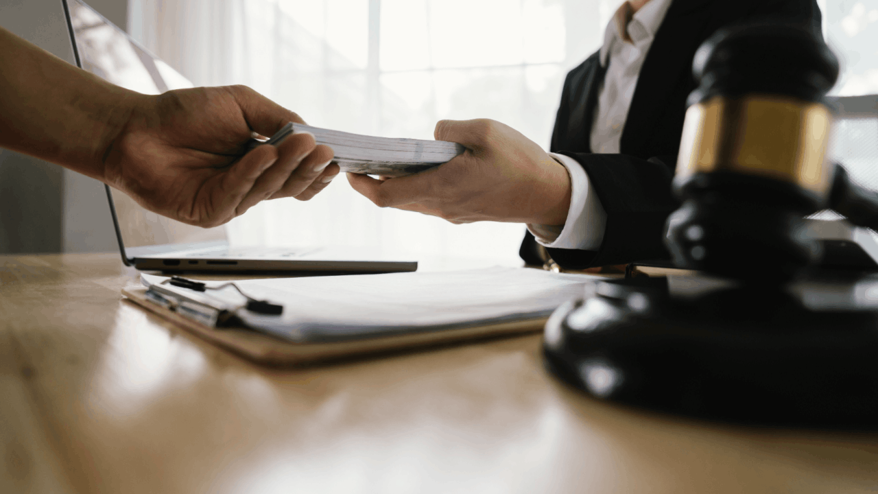 Truck accident settlement amounts discussion between lawyer and client with legal documents and a gavel