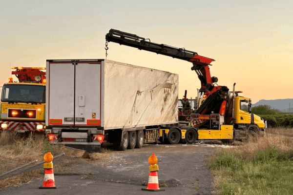 Overturned commercial truck being recovered after an accident, illustrating what happens when insurance accepts liability in a truck accident