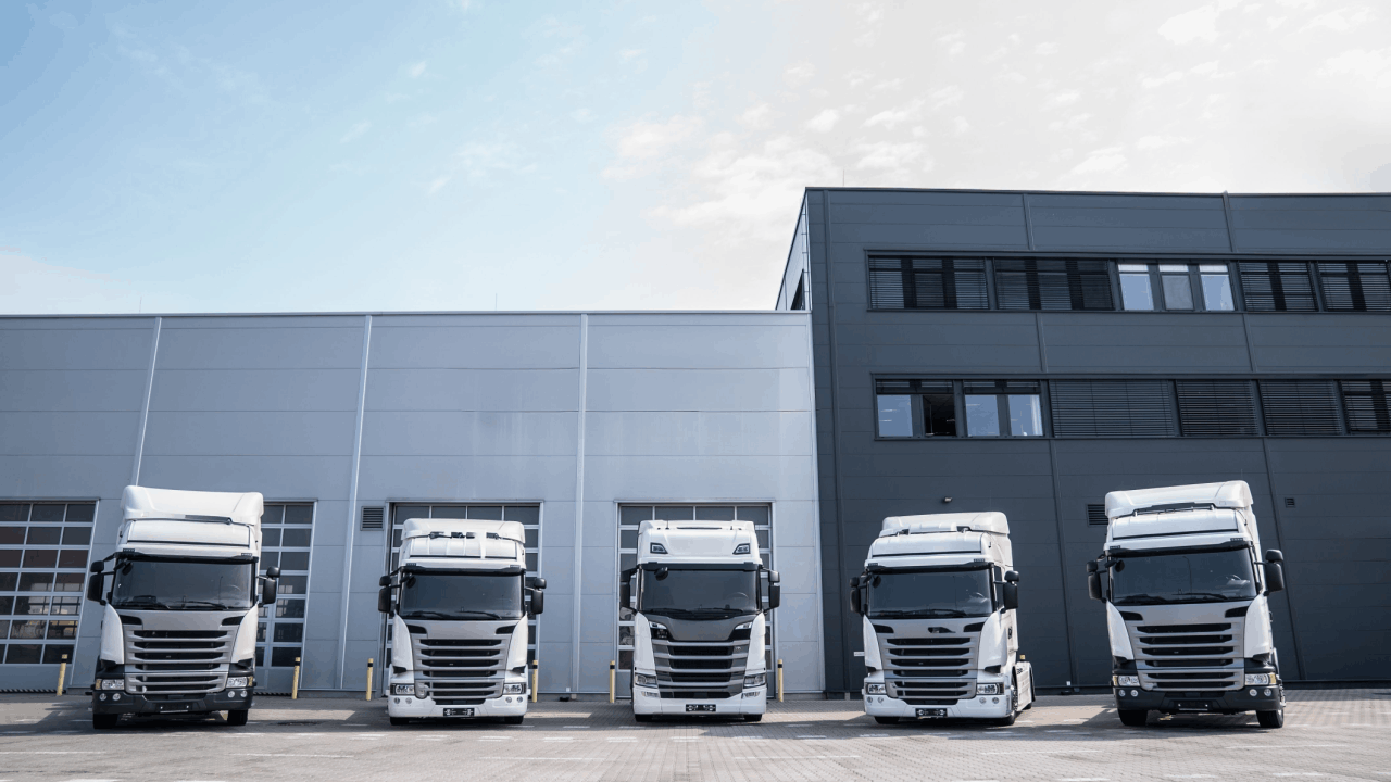 Can you sue after a truck accident - white commercial truck fleet at modern warehouse distribution center