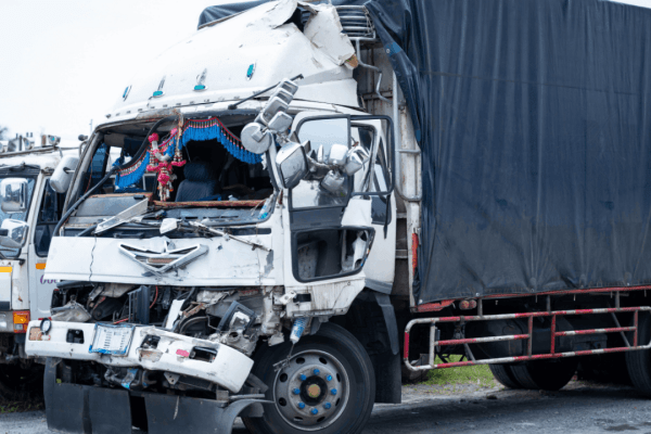 Severely damaged truck cab after collision showing what happens to a truck driver after an accident scene