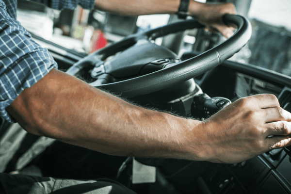 Commercial truck driver reviewing CDL accident records in truck cab to understand how long accidents stay on a CDL after a truck accident