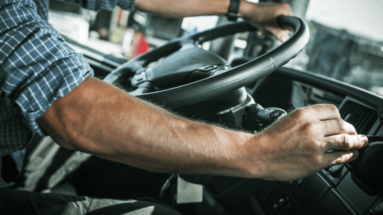 Commercial truck driver reviewing CDL accident records in truck cab to understand how long accidents stay on a CDL after a truck accident