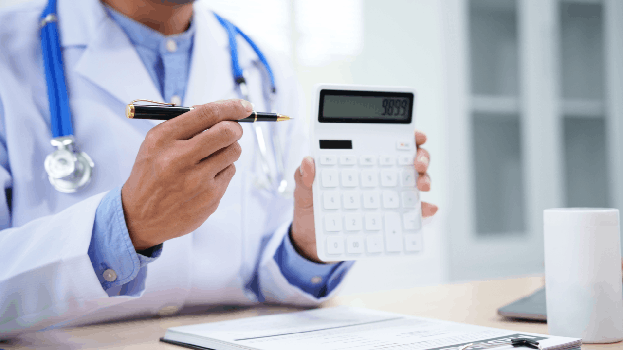 Medical expense reimbursement calculator held by doctor after trucking accident