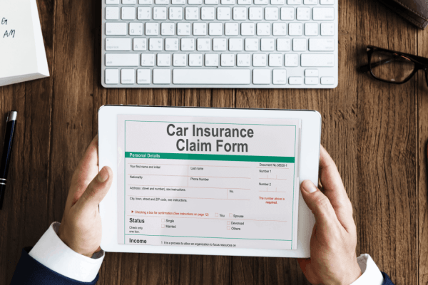 Person reviewing an insurance claim form on a tablet after a trucking accident