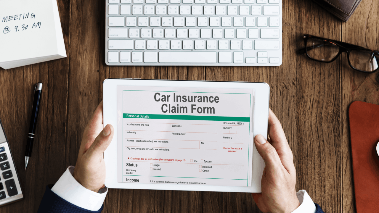Person reviewing an insurance claim form on a tablet after a trucking accident
