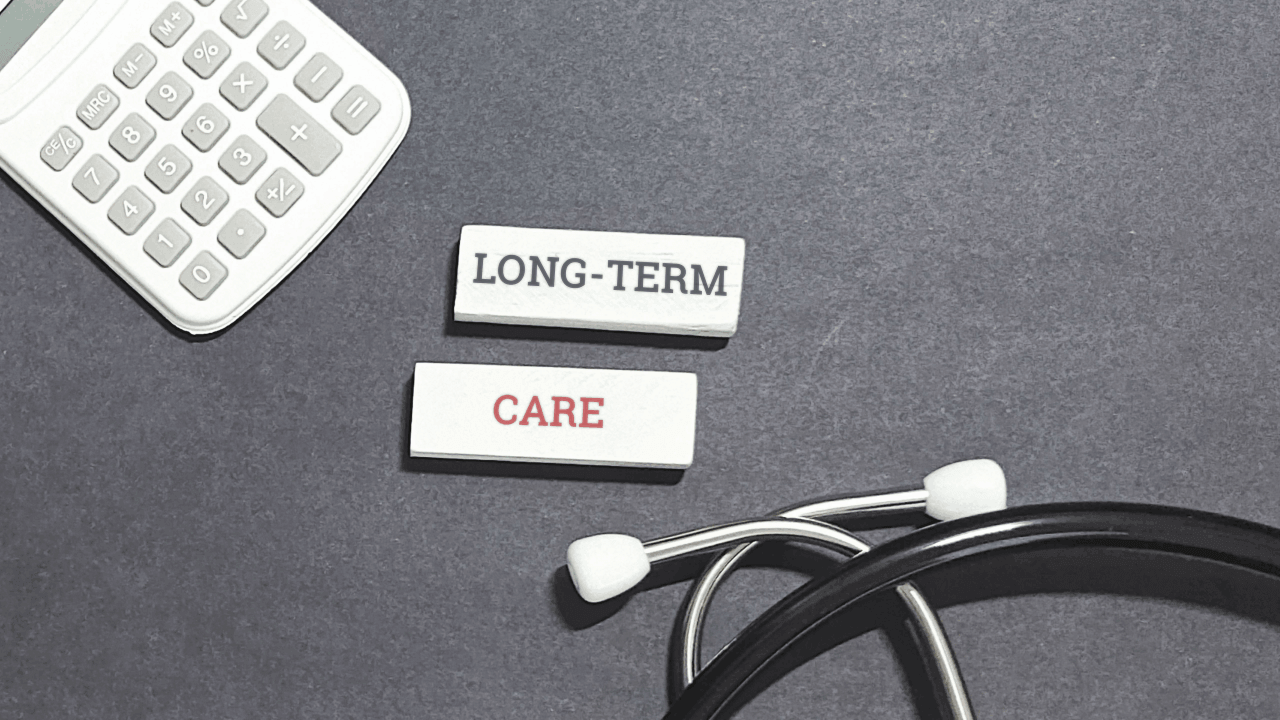 Long term medical care tiles with stethoscope and calculator on gray background