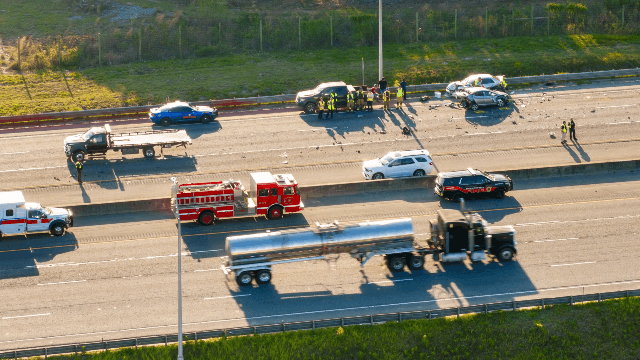 Police accident report details documented at multi-vehicle highway crash scene with emergency responders