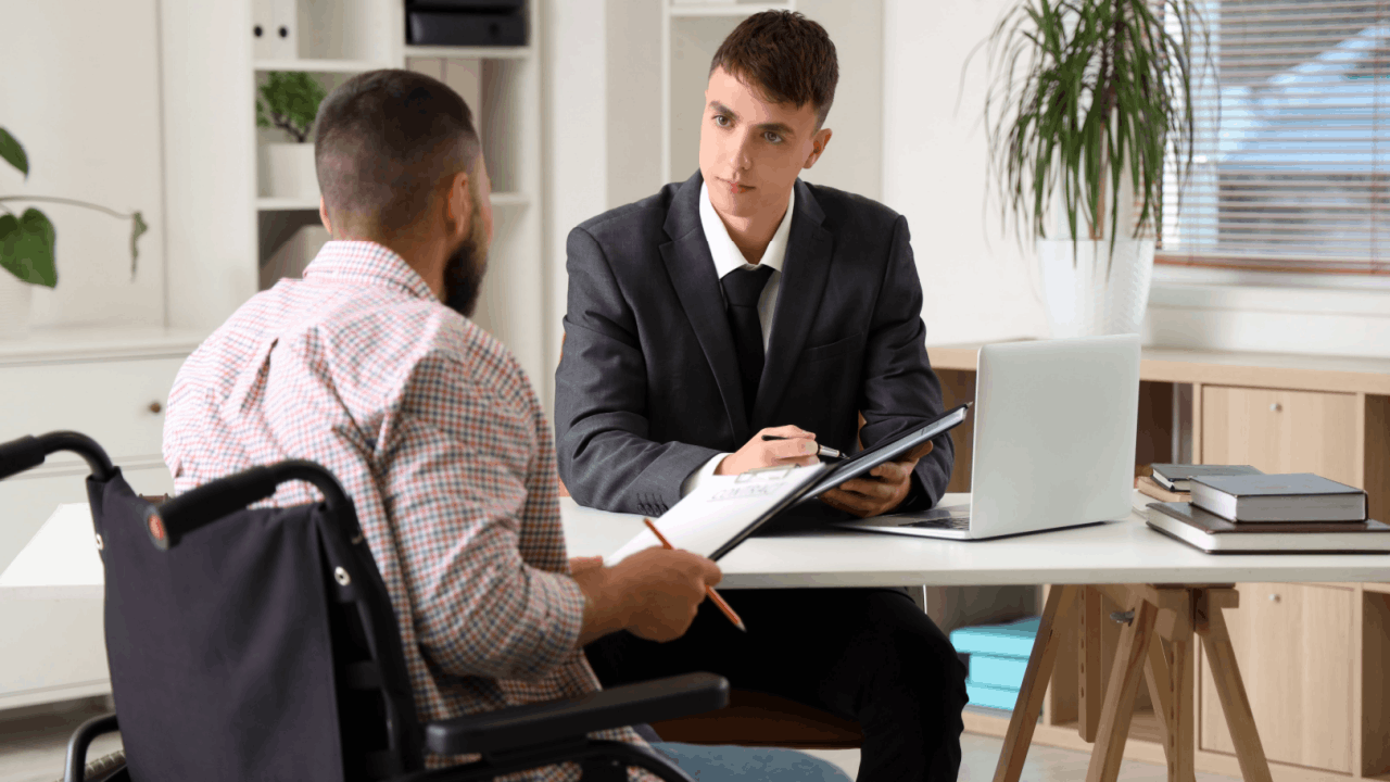 Wheelchair-bound accident victim meeting with an attorney to navigate the truck accident claims process