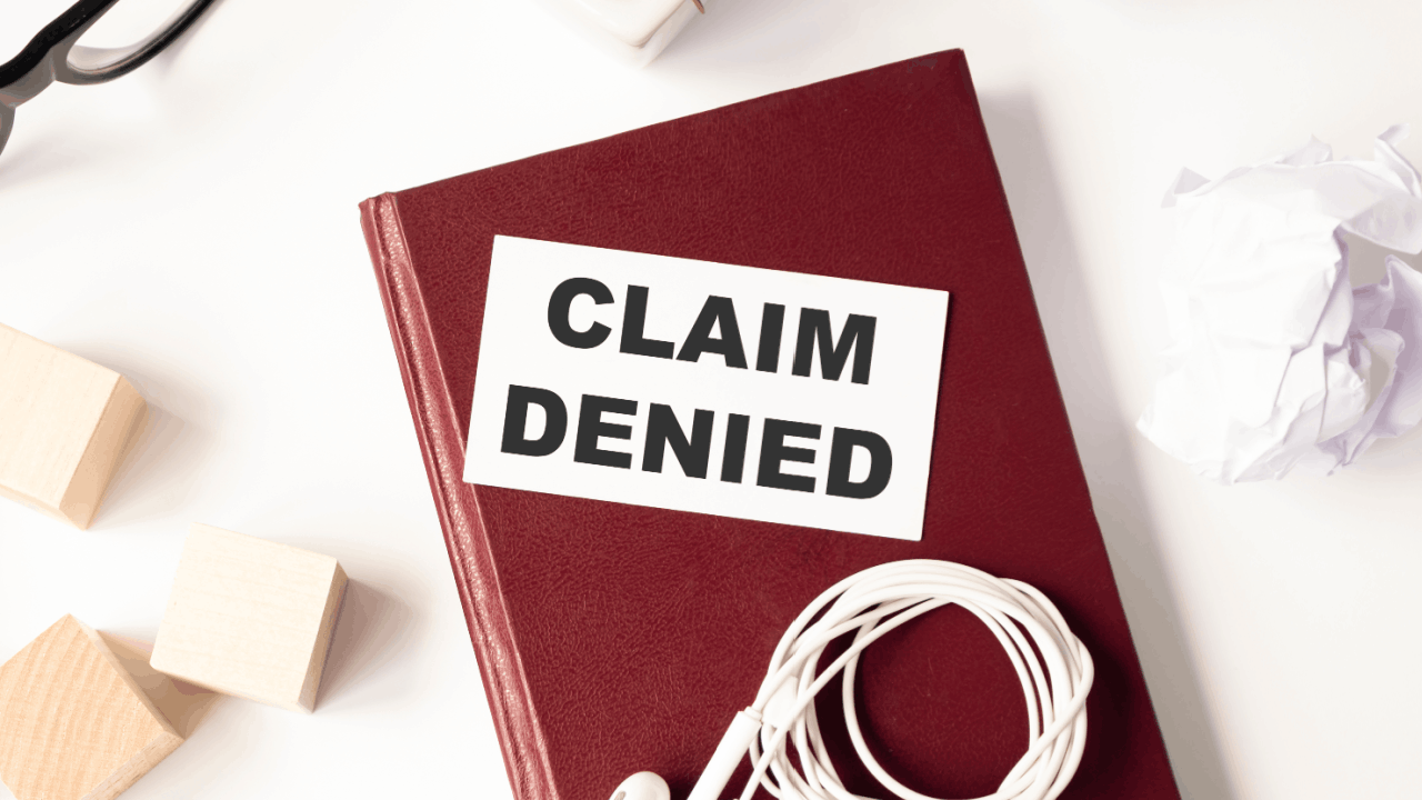 Claim denied notice on a red book representing reasons claims get denied after a truck accident