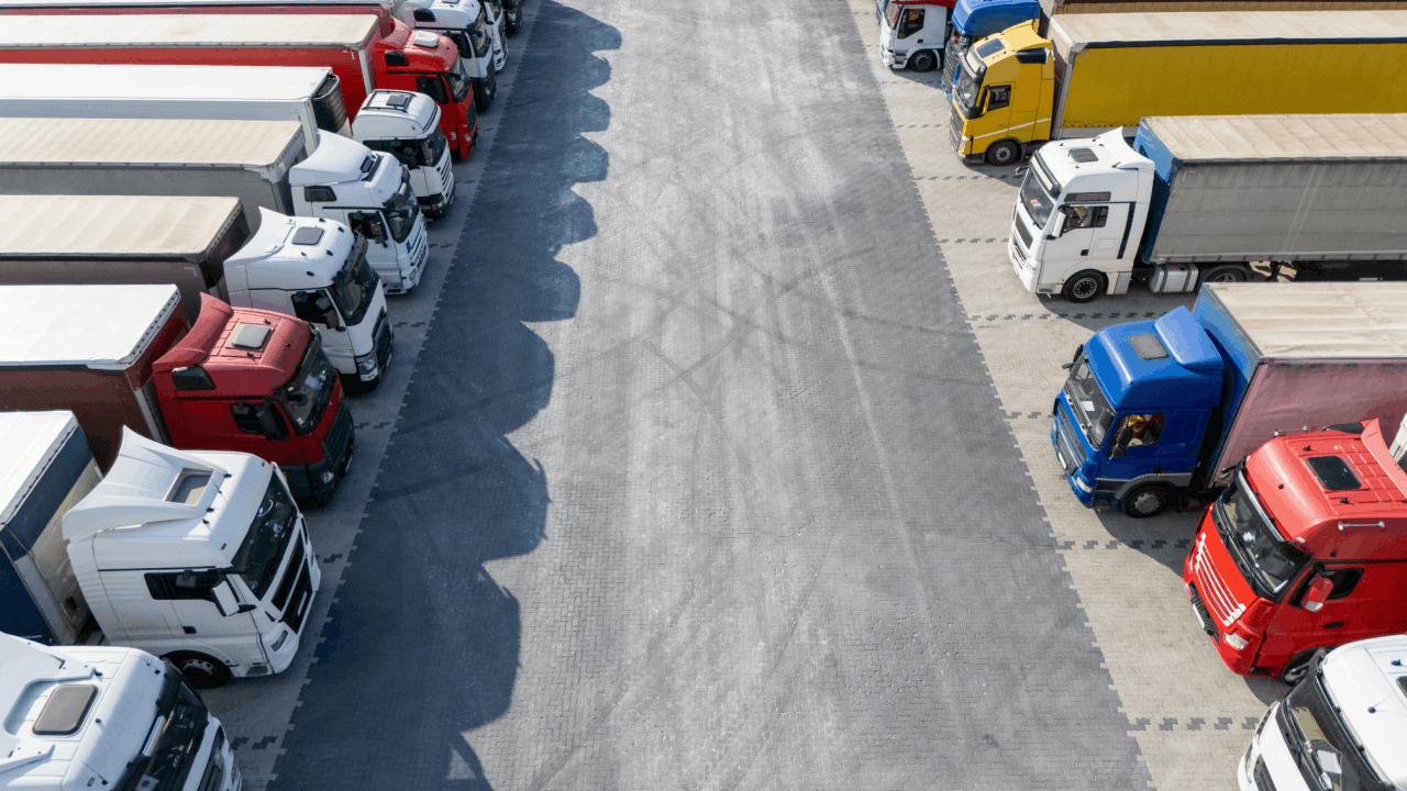 Aerial view of trucks parked in a lot, illustrating suing a trucking company for negligent hiring.